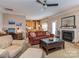Cozy living room with a fireplace, desk area, and a view of the kitchen for seamless entertaining at 2603 Willis Dr, Harrisburg, NC 28075