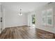 Dining area featuring wood floors, a modern chandelier, slider doors to the backyard, and bright white walls at 2710 Red Bud Ln, Fort Mill, SC 29715