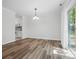 Dining area showcasing wood floors, slider doors to the backyard, and open flow to the kitchen at 2710 Red Bud Ln, Fort Mill, SC 29715