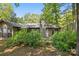 Back of property featuring exterior siding, stone chimney and lush trees at 2710 Red Bud Ln, Fort Mill, SC 29715
