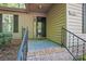 Close up of the front entrance with brick steps, black railing, and covered porch area at 2710 Red Bud Ln, Fort Mill, SC 29715