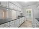 Bright kitchen featuring white cabinets, stainless appliances, and a large window with shutter at 2710 Red Bud Ln, Fort Mill, SC 29715