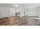 Open-concept living area with a view into the kitchen, featuring updated flooring and lighting at 2710 Red Bud Ln, Fort Mill, SC 29715