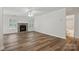 Spacious living room with wood floors, stone fireplace, ample natural light, and a ceiling fan at 2710 Red Bud Ln, Fort Mill, SC 29715