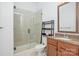 Modern bathroom featuring a glass shower, granite countertop, and wood vanity at 2810 Selwyn Ave # 410, Charlotte, NC 28209