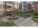 Beautiful courtyard featuring a stone fountain, lush greenery, and a cozy seating area at 2810 Selwyn Ave # 410, Charlotte, NC 28209