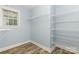 Walk-in closet with wire shelving and wood-look flooring at 3004 Point Clear Dr, Tega Cay, SC 29708