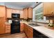 Functional kitchen featuring wooden cabinets, modern appliances, and tile backsplash at 3004 Point Clear Dr, Tega Cay, SC 29708