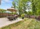 Backyard featuring a patio, table, and manicured landscaping at 3505 Trent St, Charlotte, NC 28209