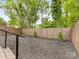 Backyard showcasing mulch area with privacy fence and steps leading to the patio at 3505 Trent St, Charlotte, NC 28209
