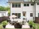 Exterior view of home's backyard featuring a patio, table, and manicured landscaping at 3505 Trent St, Charlotte, NC 28209
