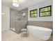 Luxurious bathroom with a glass-enclosed shower and freestanding tub, complemented by large windows at 3505 Trent St, Charlotte, NC 28209