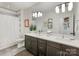 Bathroom featuring a dual sink vanity, large mirror, and modern lighting at 3505 Trent St, Charlotte, NC 28209