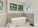 Modern bathroom features a sleek, stand-alone bathtub with stylish fixtures and a large window view at 3505 Trent St, Charlotte, NC 28209