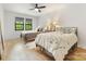Bright bedroom featuring two beds, wood floors, and natural light at 3505 Trent St, Charlotte, NC 28209