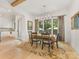Elegant dining room featuring hardwood floors, large windows, modern chandelier, and open kitchen view at 3505 Trent St, Charlotte, NC 28209