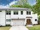 Charming two-story home with white brick, a wooden garage pergola, and a well-manicured lawn at 3505 Trent St, Charlotte, NC 28209