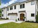 Elegant two-story home featuring white brick, dark window trim, and a beautifully landscaped front yard at 3505 Trent St, Charlotte, NC 28209
