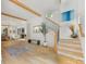 Open-concept foyer with wood staircase, a decorative tree, and hardwood flooring throughout at 3505 Trent St, Charlotte, NC 28209