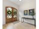 Bright foyer showcasing wooden double doors, light hardwood floors, and stylish wall decor at 3505 Trent St, Charlotte, NC 28209