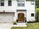 Inviting front entrance with wood double doors, a concrete walkway, and manicured landscaping at 3505 Trent St, Charlotte, NC 28209