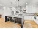 Modern kitchen with a large island, white cabinets, pendant lighting, and stainless steel appliances at 3505 Trent St, Charlotte, NC 28209