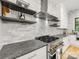 Modern kitchen with stainless steel appliances, granite countertops, and open shelving at 3505 Trent St, Charlotte, NC 28209