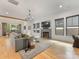 Comfortable living room with large windows, a fireplace, hardwood floors, and a modern chandelier at 3505 Trent St, Charlotte, NC 28209