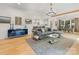 Spacious living room featuring hardwood floors, stylish furniture, and an open layout to the kitchen at 3505 Trent St, Charlotte, NC 28209
