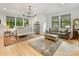 Bright bedroom featuring an iron bed frame, leather couch, patterned rug, and lots of natural light at 3505 Trent St, Charlotte, NC 28209