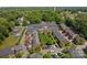 Aerial view of a community with well-maintained lawns, parking, and beautiful tree coverage at 413 Nobles Way, Belmont, NC 28012