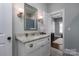 Well-lit bathroom vanity with granite countertop, decorative mirror, and stylish sconces at 413 Nobles Way, Belmont, NC 28012
