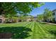 Scenic view of townhomes surrounded by manicured lawns and mature trees, creating a serene setting at 413 Nobles Way, Belmont, NC 28012
