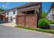 Brick townhouse with covered patio and privacy wall, showcasing outdoor living space at 413 Nobles Way, Belmont, NC 28012