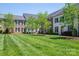 Row of townhomes showcasing a lush green lawn, trees, and manicured landscaping at 413 Nobles Way, Belmont, NC 28012