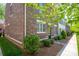 Brick townhome with lush landscaping, neat walkway, and well-maintained exterior details at 413 Nobles Way, Belmont, NC 28012