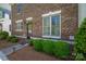 Brick home exterior with lush landscaping and visible house number at 413 Nobles Way, Belmont, NC 28012
