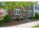 Charming brick townhouse with well-manicured landscaping and inviting entrance at 413 Nobles Way, Belmont, NC 28012
