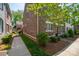 Brick townhome featuring a walkway, well-manicured landscaping, and lush green lawn at 413 Nobles Way, Belmont, NC 28012
