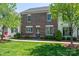 Inviting brick townhome with manicured lawn, lush landscaping, and a stylish front entrance at 413 Nobles Way, Belmont, NC 28012