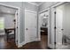 Hallway offering views of an office and a bedroom with hardwood floors and neutral wall colors at 413 Nobles Way, Belmont, NC 28012