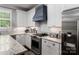 Updated kitchen with stainless steel appliances, granite countertops, and ample cabinetry at 413 Nobles Way, Belmont, NC 28012