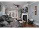 Cozy living room with a fireplace, large sofa, and french doors to patio at 413 Nobles Way, Belmont, NC 28012