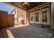 Inviting brick patio with covered area and ceiling fan, perfect for relaxing or entertaining outdoors at 413 Nobles Way, Belmont, NC 28012