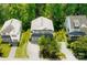 Aerial view of a charming home nestled amongst mature trees, showcasing its well-manicured lawn at 4825 Samuel Richard St, Kannapolis, NC 28083