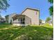 Side view showing a backyard with sunroom addition to the house at 4825 Samuel Richard St, Kannapolis, NC 28083