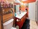 Well-lit bathroom with double vanity, functional shelving, and neutral tile floors at 4825 Samuel Richard St, Kannapolis, NC 28083