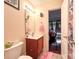 Bathroom with single vanity, tile floor, and view into adjacent room at 4825 Samuel Richard St, Kannapolis, NC 28083