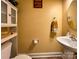 Charming half bathroom features a pedestal sink, mirror, and wall decor at 4825 Samuel Richard St, Kannapolis, NC 28083