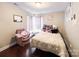 Cozy bedroom featuring a bed with colorful pillows and a comfortable armchair at 4825 Samuel Richard St, Kannapolis, NC 28083